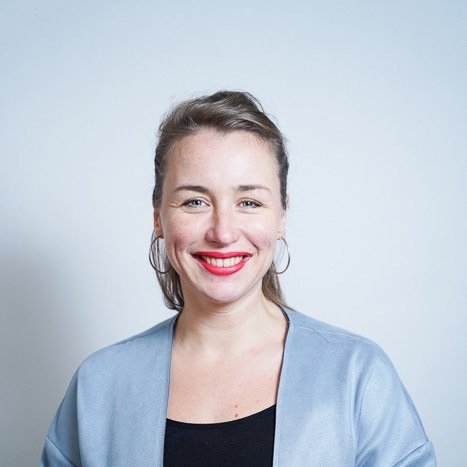 Portrait of Lia Weitz wearing a blue-grey jacket